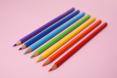 Photo of Many colorful wooden pencils on pink background