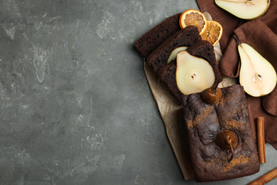 Photo of Flat lay composition with tasty pear bread on grey table, space for text. Homemade cake