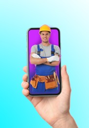 Image of Woman with smartphone calling professional repairman on color background, closeup