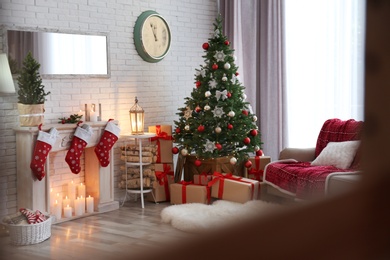 Photo of Stylish interior with beautiful Christmas tree and decorative fireplace