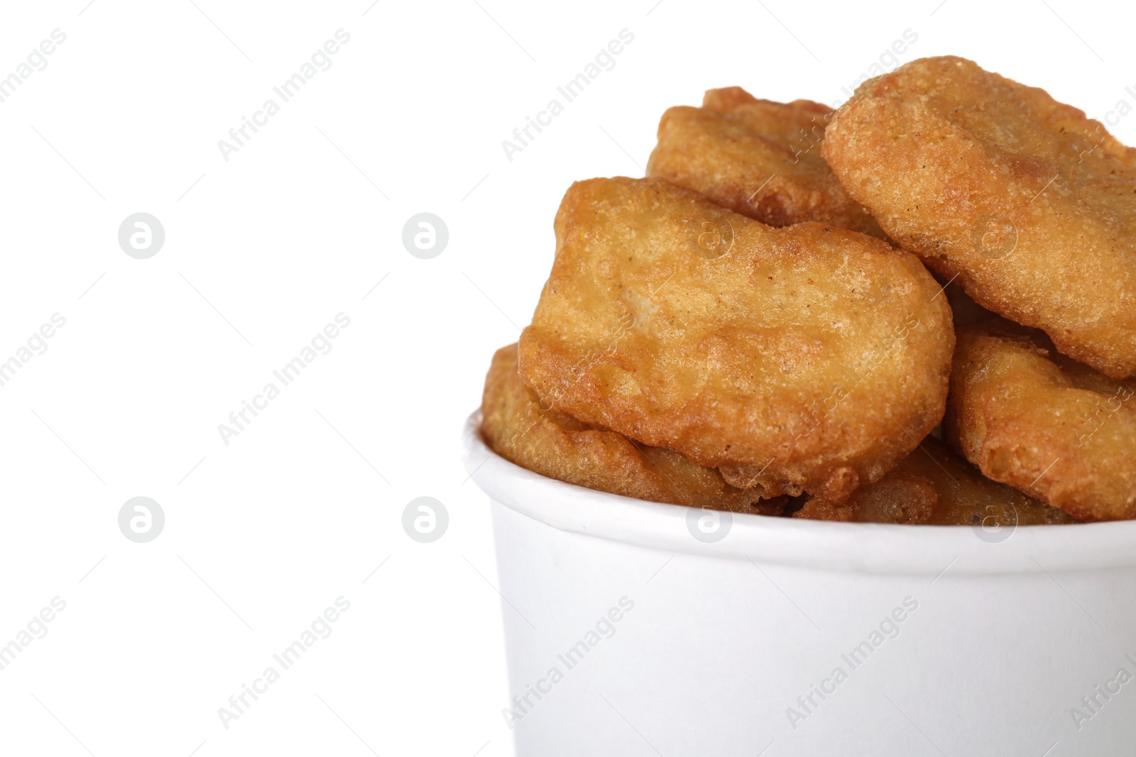 Photo of Bucket with tasty chicken nuggets isolated on white, closeup