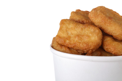 Photo of Bucket with tasty chicken nuggets isolated on white, closeup