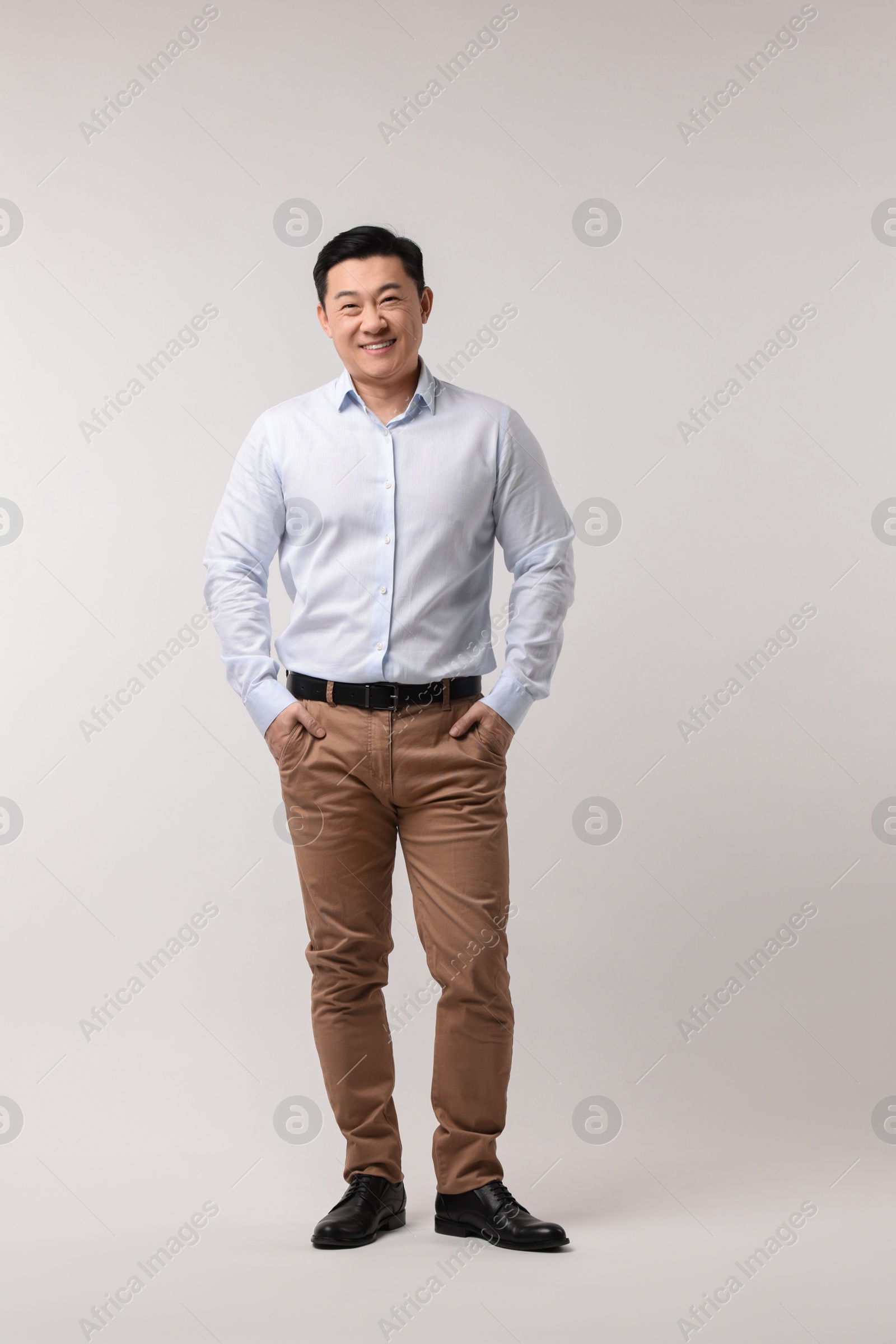 Photo of Full length portrait of happy man on light background