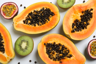 Fresh ripe papaya and other fruits on white background, top view