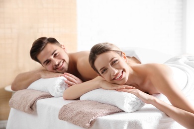 Photo of Romantic young couple relaxing in spa salon