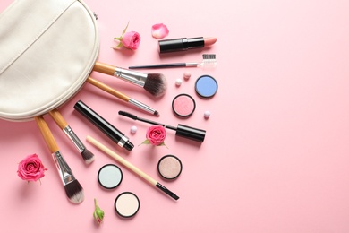 Flat lay composition with products for decorative makeup on pastel pink background