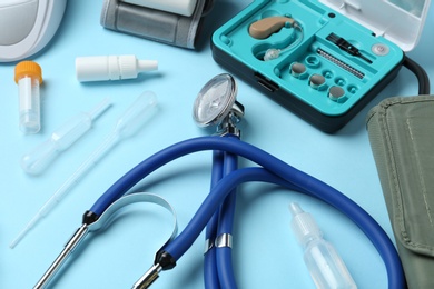 Photo of Stethoscope and different medical objects on color background
