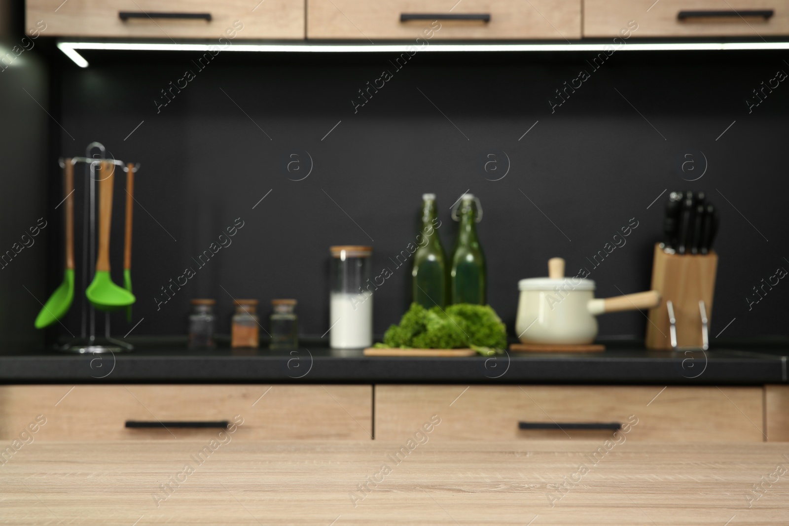 Photo of Countertop and blurred view of kitchen interior on background