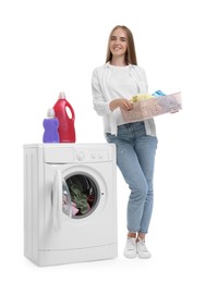 Photo of Beautiful young woman with laundry basket near washing machine on white background