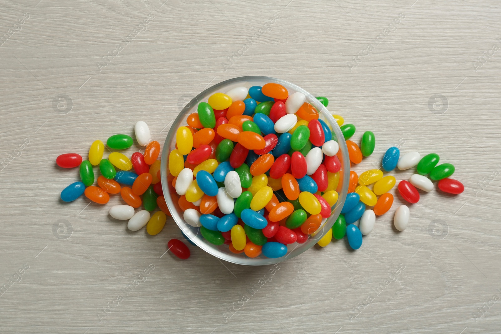 Photo of Top view of bowl with jelly beans on table