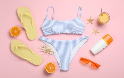 Flat lay composition with beach objects on pink background
