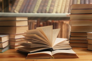 Different books on wooden table in library