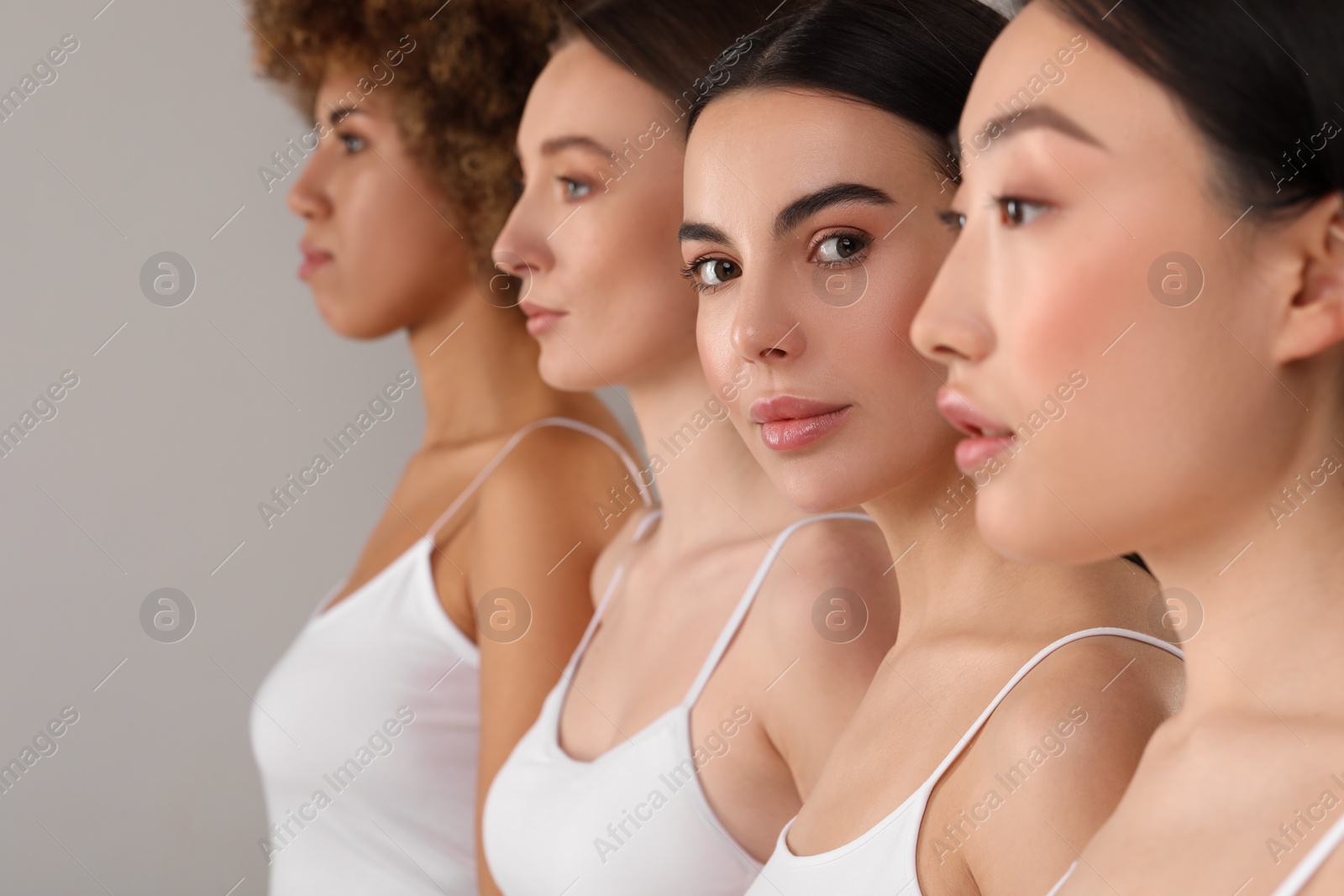 Photo of Beautiful young women with healthy skin on gray background