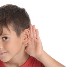 Cute little boy with hearing problem on white background, closeup