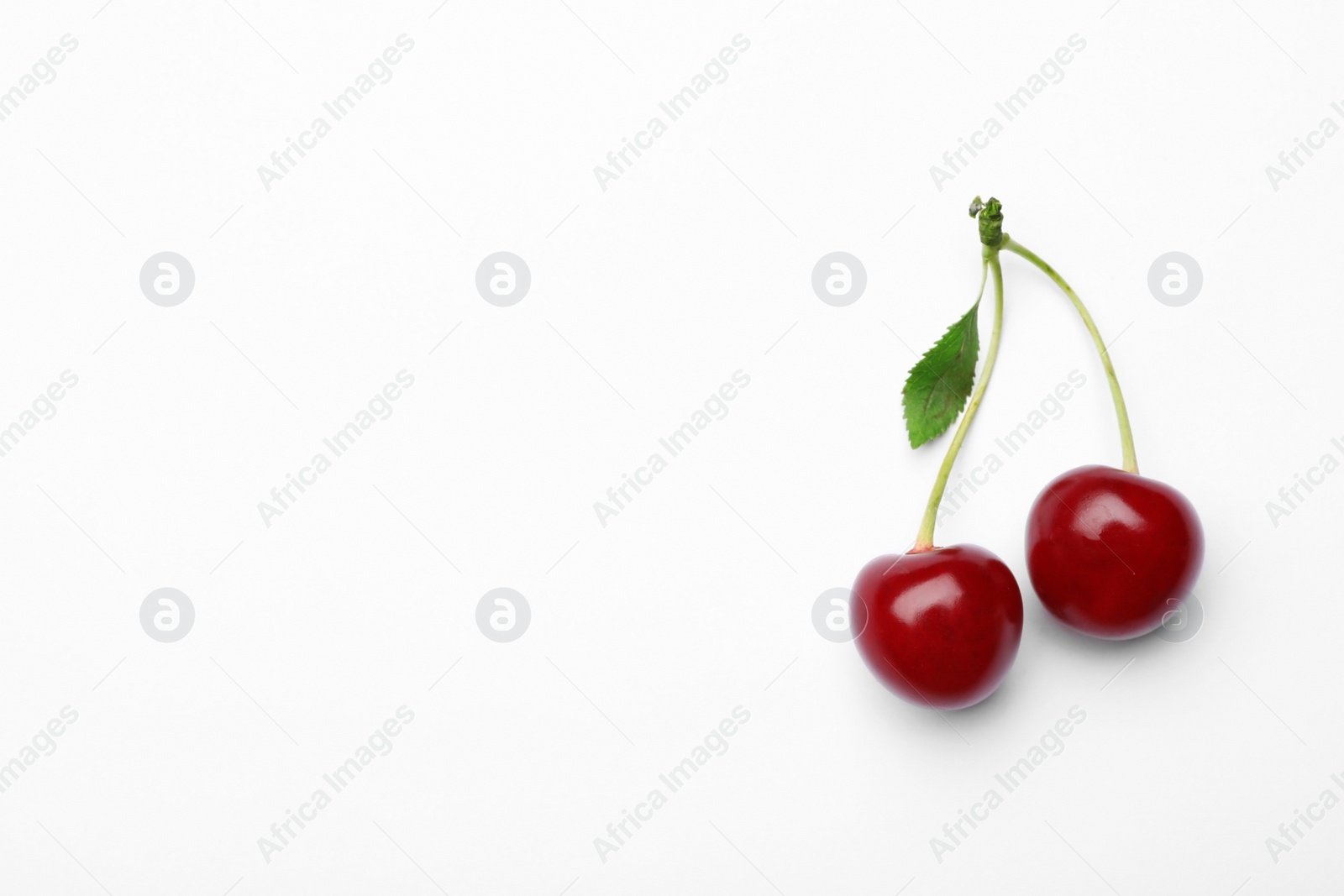 Photo of Delicious ripe sweet cherries with leaf on white background