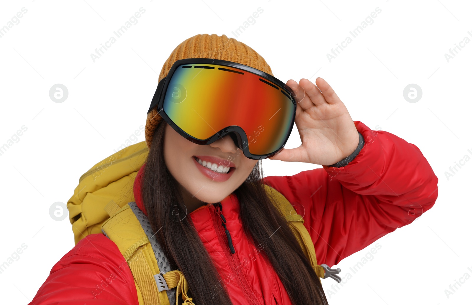 Photo of Smiling woman in ski goggles taking selfie on white background