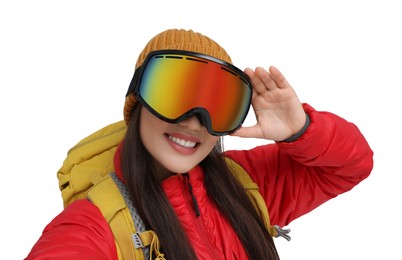 Smiling woman in ski goggles taking selfie on white background