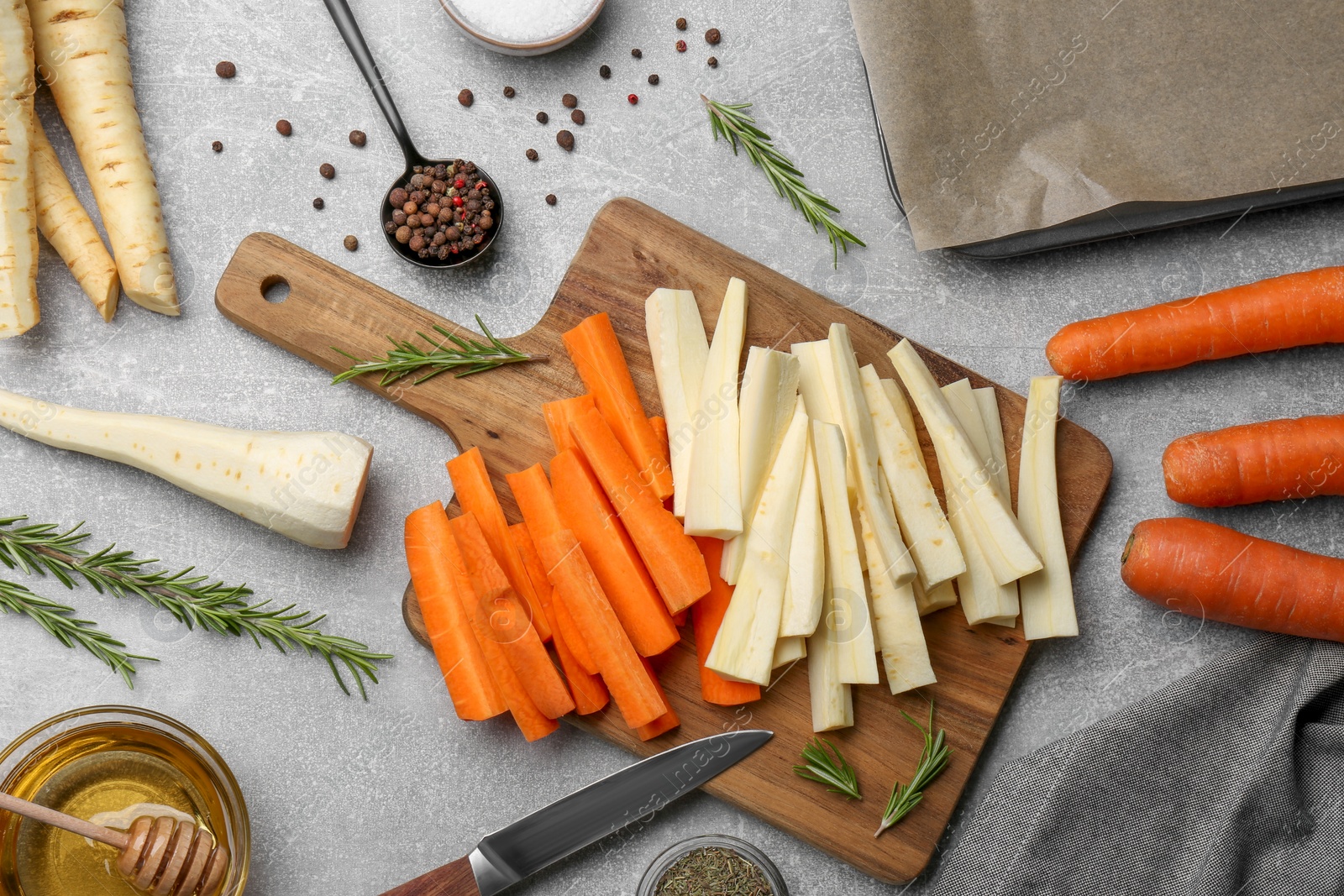 Photo of Flat lay composition with parsnips, carrots and other products on light grey table