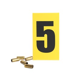 Shell casings and crime scene marker with number five isolated on white
