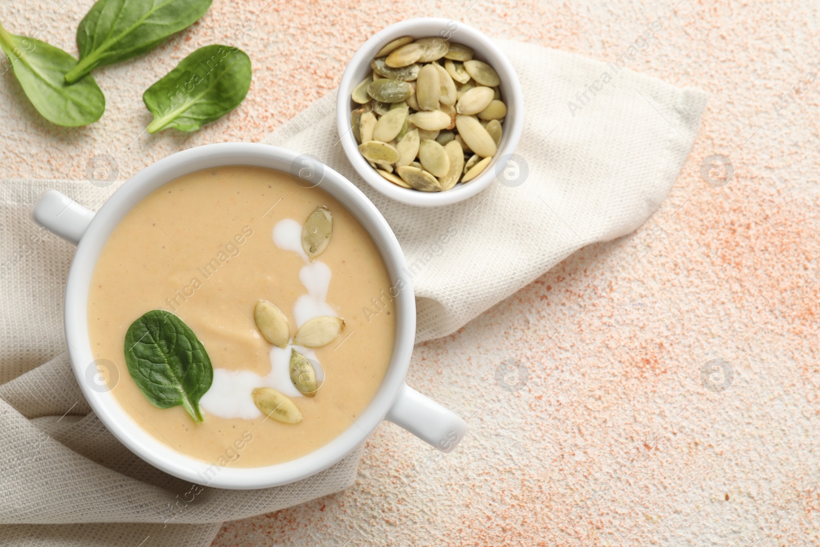 Photo of Healthy cream soup high in vegetable fats on color textured table, flat lay. Space for text