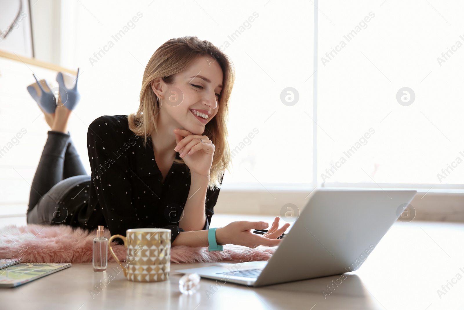 Photo of Young blogger with laptop on floor at home