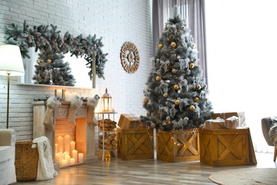 Stylish interior with decorated Christmas tree in living room