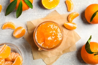 Photo of Flat lay composition with delicious tangerine jam on light grey table