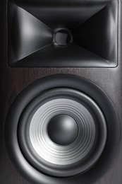 Photo of One wooden sound speaker as background, closeup