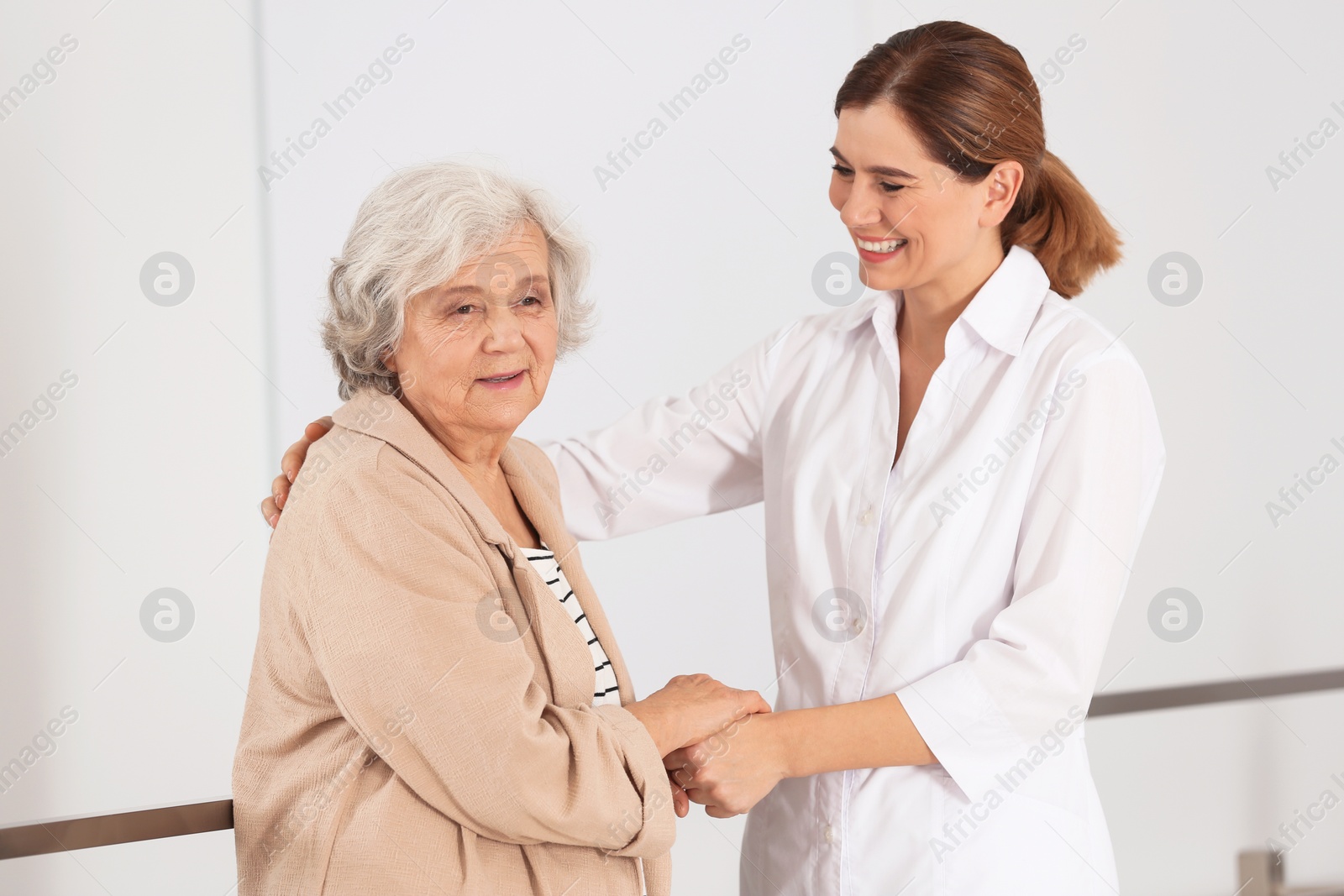 Photo of Elderly woman with female caregiver in room