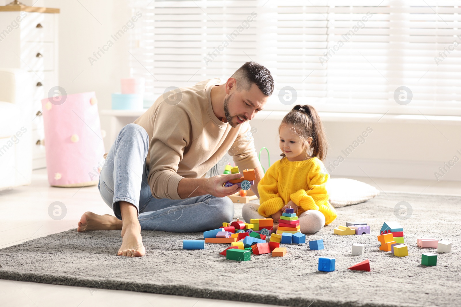 Photo of Father playing with his child at home