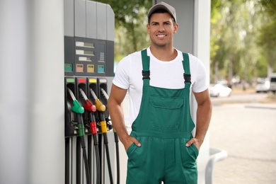 Worker in uniform at modern gas station