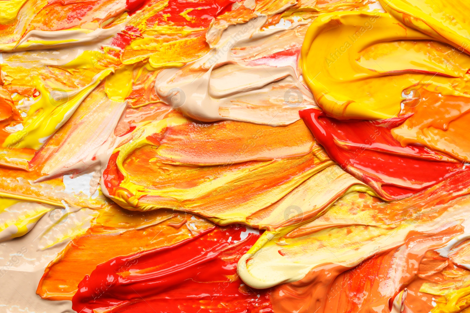 Photo of Beautiful strokes of colorful oil paints as background, closeup