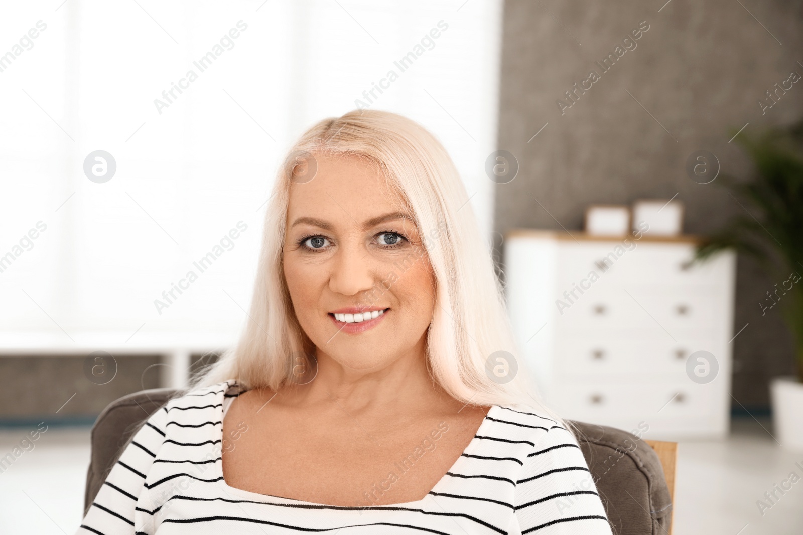 Photo of Portrait of mature woman with beautiful face indoors