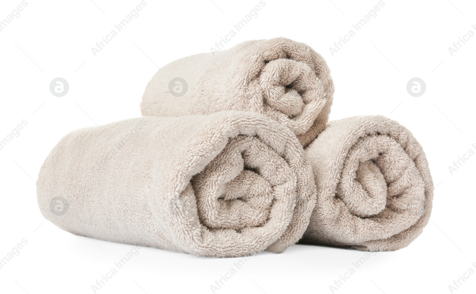 Photo of Rolled clean beige towels on white background