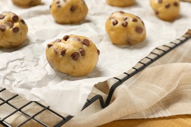 Photo of Uncooked chocolate chip cookies on table, closeup
