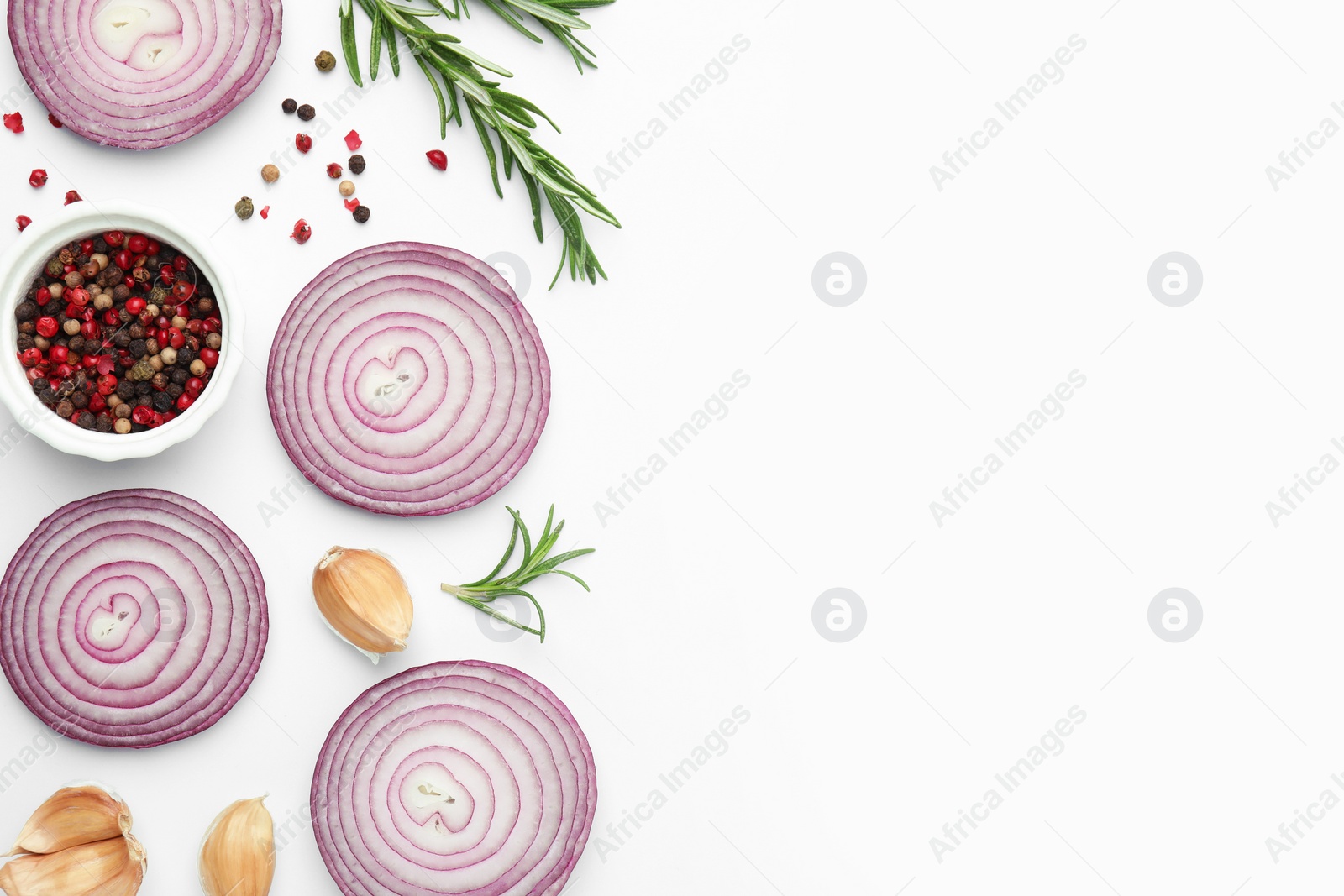 Photo of Fresh red onions, garlic, rosemary and spices on white background, flat lay. Space for text