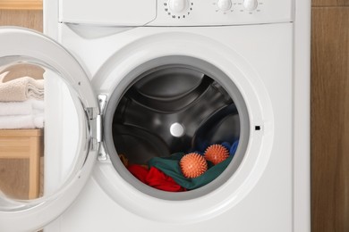 Dryer balls and clothes in washing machine, closeup