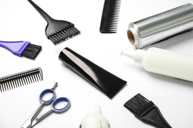 Photo of Professional tools for hair dyeing on white background