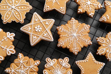 Photo of Tasty Christmas cookies on cooling rack, top view