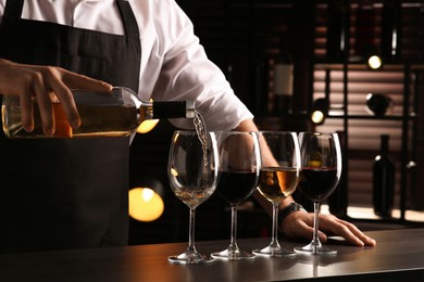 Bartender preparing wine tasting set at counter indoors, closeup