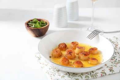 Photo of Delicious fried scallops served on white. Space for text