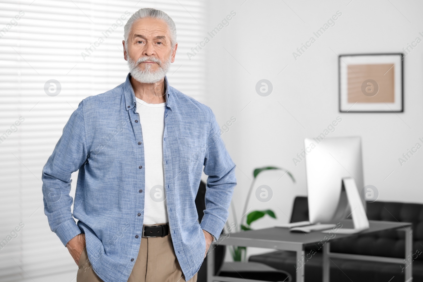 Photo of Portrait of handsome senior man in office. Space for text