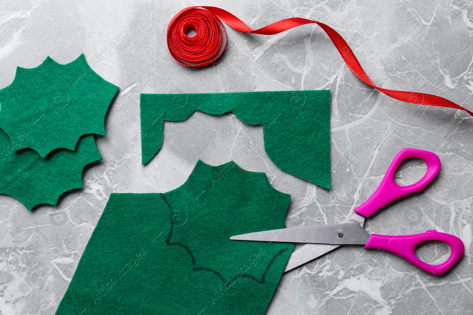 Photo of Scissors and materials for making mistletoe branch on grey table, flat lay