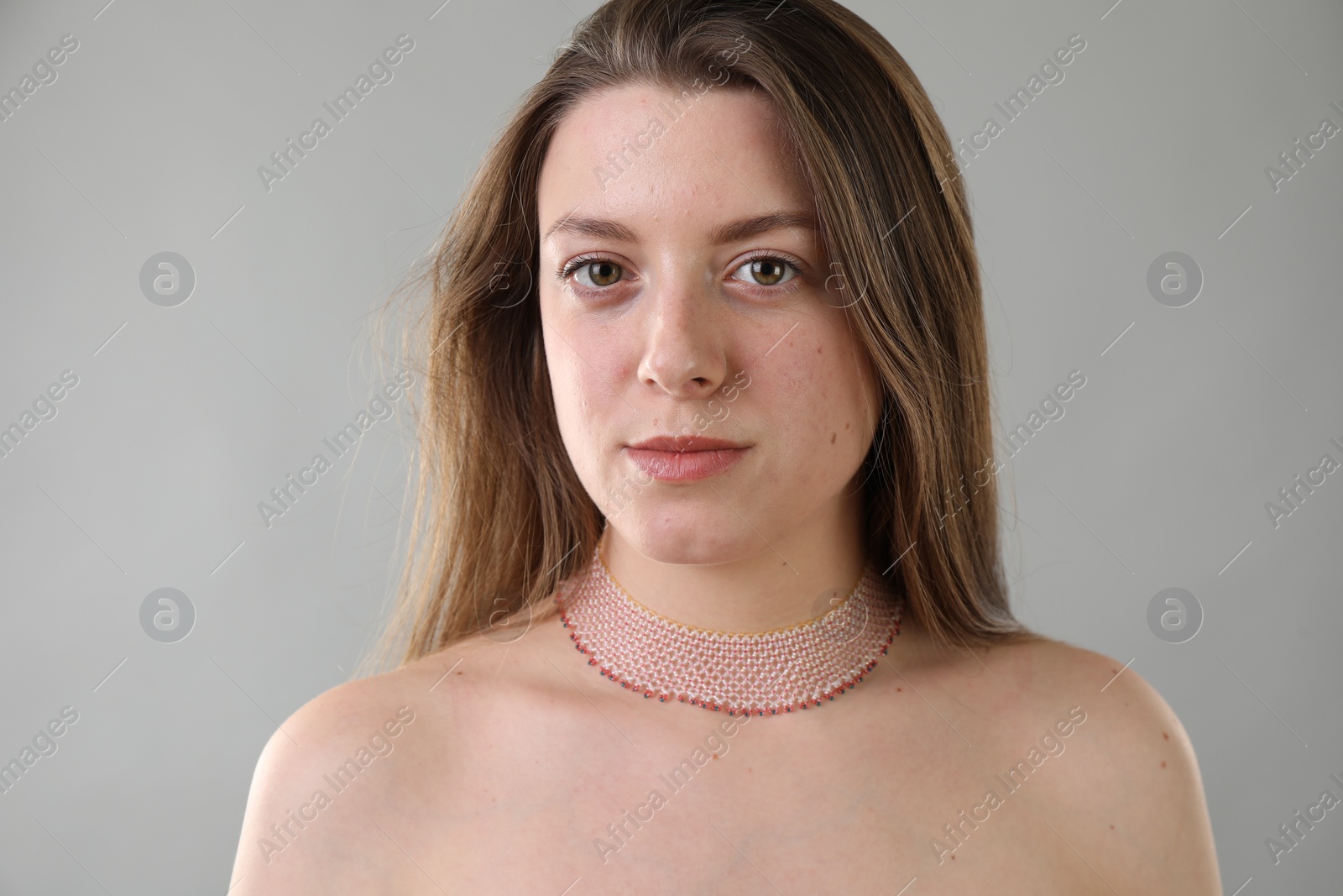 Photo of Portrait of beautiful young woman on grey background