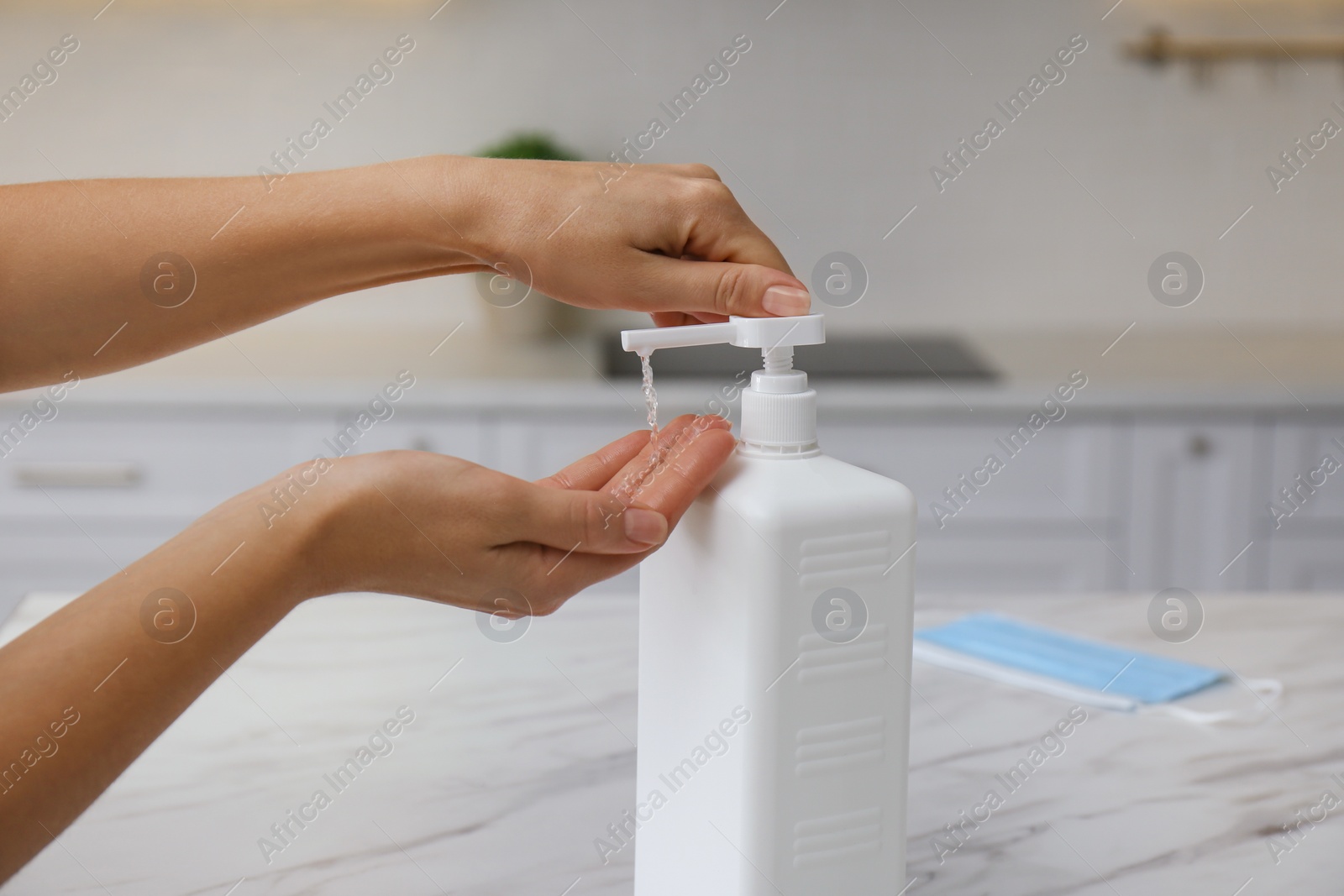 Photo of Woman applying hand sanitizer indoors, closeup. Personal hygiene during COVID-19 pandemic