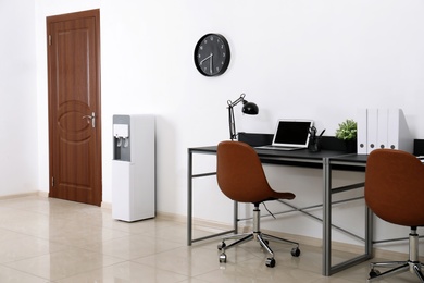 Modern water cooler in stylish office interior