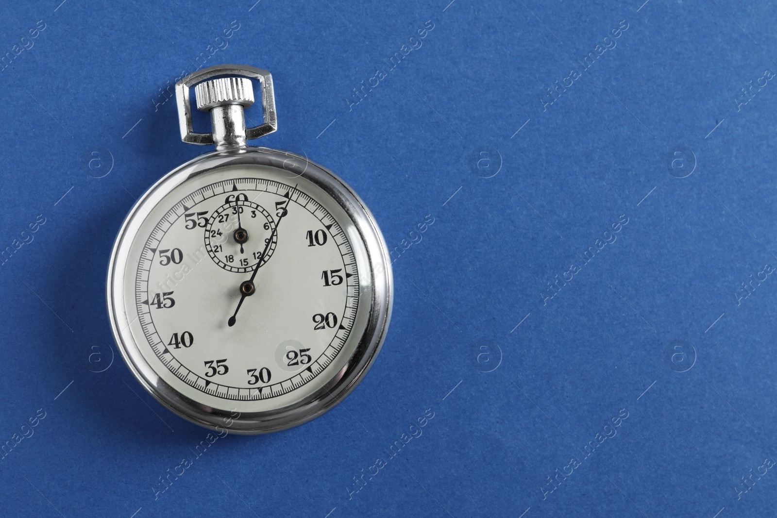 Photo of Vintage timer on blue background, top view with space for text. Measuring tool