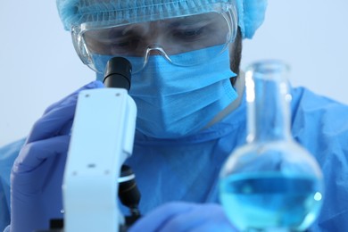 Photo of Scientist working with microscope indoors, closeup. Medical research