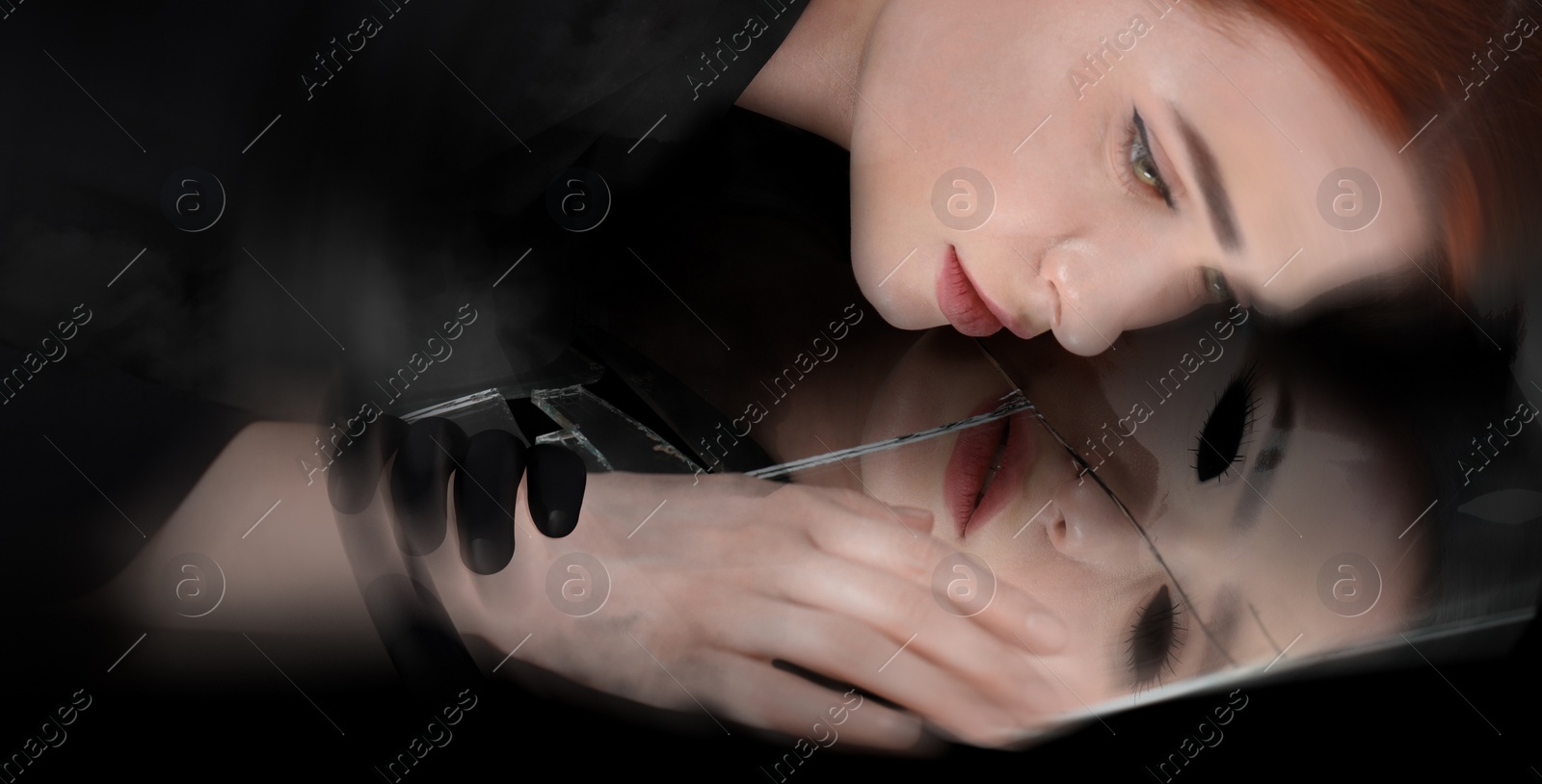 Image of Suffering from hallucinations. Woman lying on broken mirror, demon in reflection touching her hand