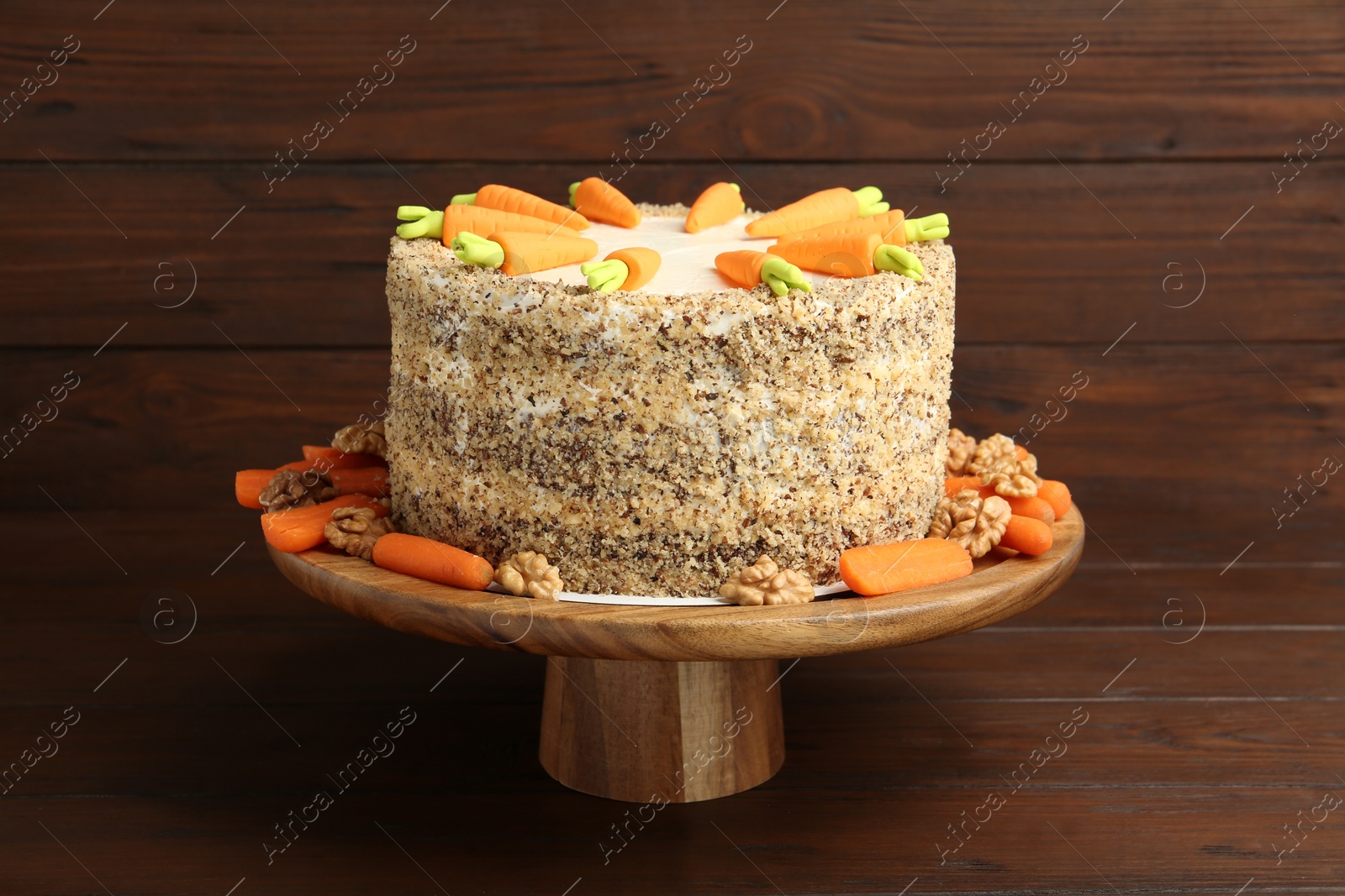 Photo of Stand with delicious carrot cake on wooden background